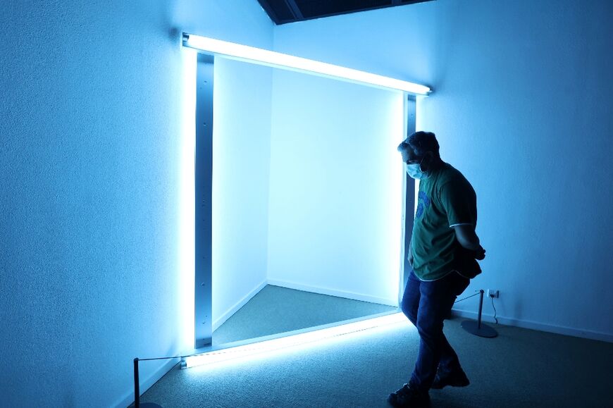 A visitor looks at an installation by American artist Dan Flavin: The museum in Tehran also holds an important collection of Iranian modern and contemporary art