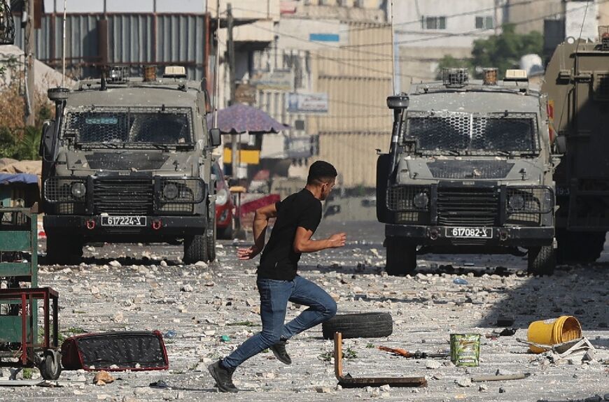 Israeli military vehicles move into the old city of Nablus sparking clashes with Palestinian protesters