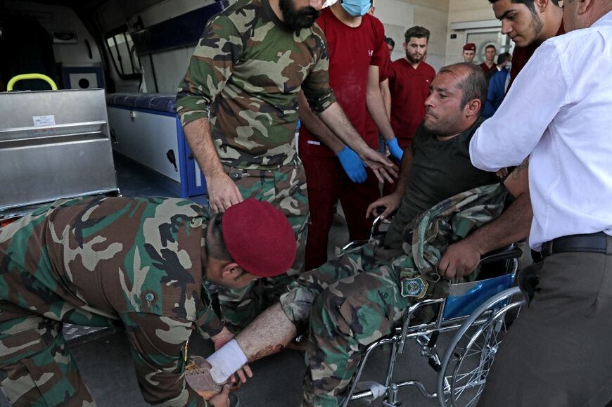 A wounded member of the Kurdish Democratic Party is transported to a hospital following strikes by Iran on the village of Altun Kupri, south of the capital Arbil, in Iraq's autonomous Kurdistan region 