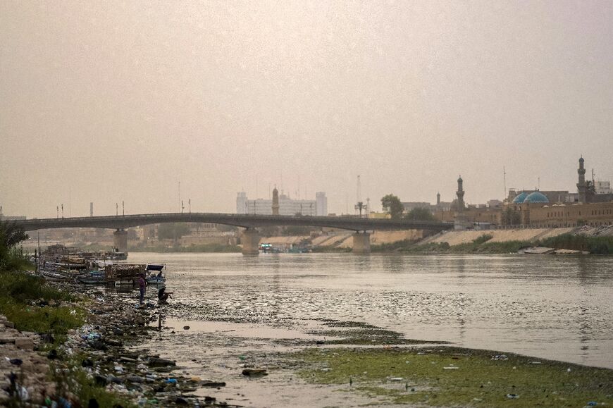 Thinning and polluted: the Tigris River flows under the Ahrar bridge in central Baghdad 