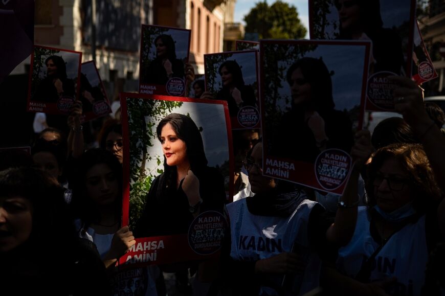 Protestors hold up a picture of 22-year-old Mahsa Amini during a solidarity demonstration outside the Iranian consulate in Istanbul on September 29