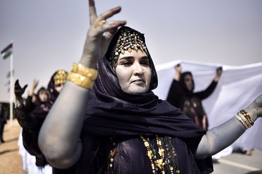 Sahrawi women dance following a military parade at a Sahrawi refugee camp in Algeria, near the southwestern city of Tindouf, on February 27, 2021