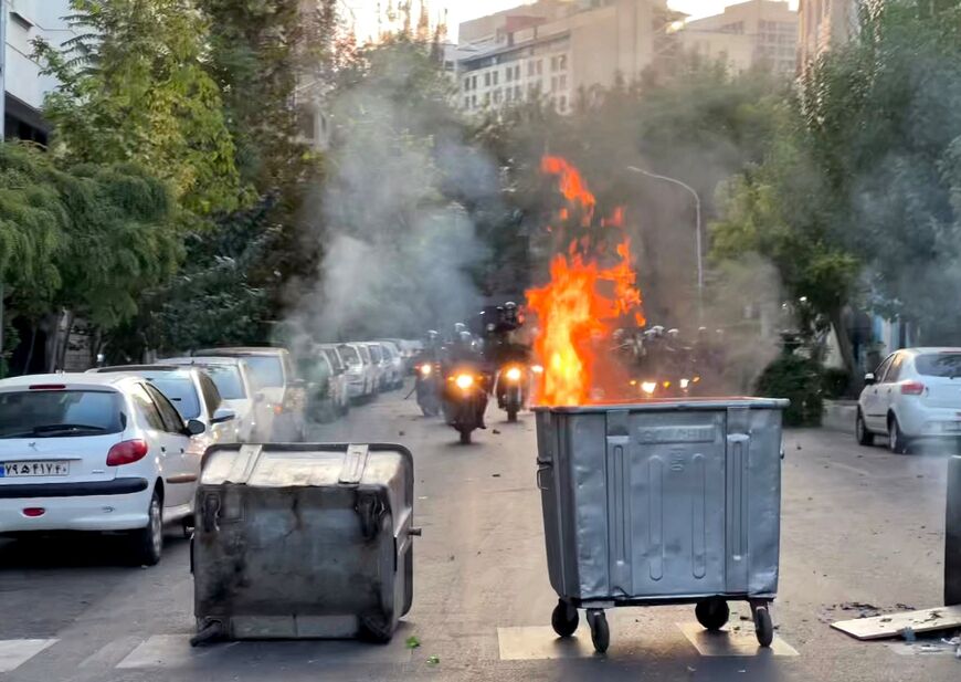 A picture obtained by AFP outside Iran shows a bin burning during a protest in Tehran on September 20, 2022
