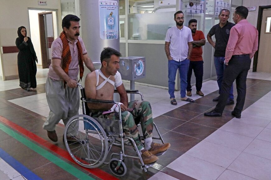 A wounded manat a hospital following strikes by Iran on the village of Altun Kupri, south of the capital Arbil, in Iraq's autonomous Kurdistan region on September 28, 2022