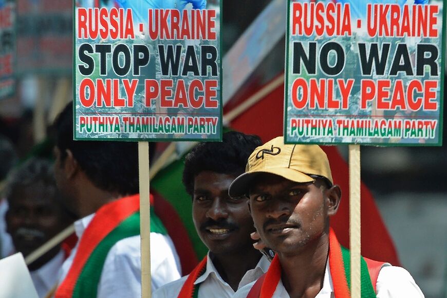 Members of the Puthiya Tamilagam party hold placards for a peaceful end to Russia's invasion of Ukraine at a March 2022 demonstration in Chennai 