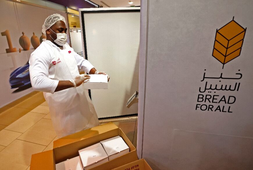 A man loads a vending machine that gives out free bread in Dubai