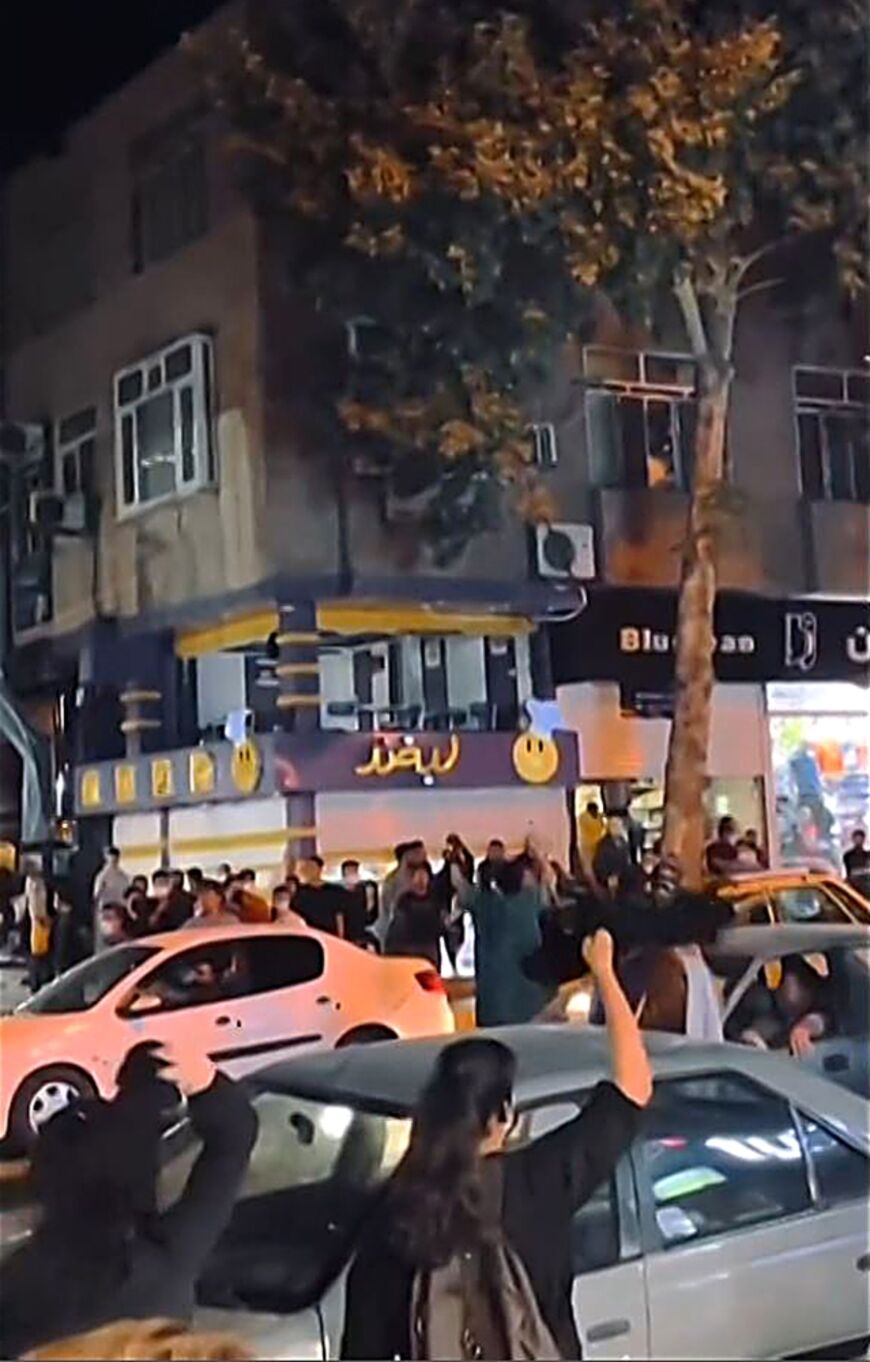 This grab taken from a UGC video of anonymous source shows Iranian women waving their headscarves above their heads in a street in Sanandaj, capital of Kurdistan, home province of Mahsa Amini