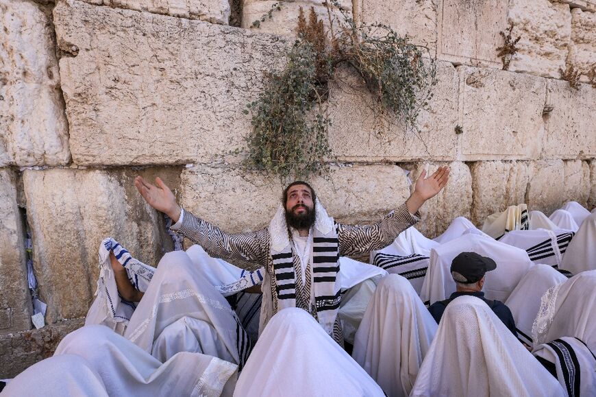 Jewish men perform the annual Cohanim prayer (priest's blessing) during the holiday of Sukkot, or the Feast of the Tabernacles, at the Western Wall in Jerusalem on October 12