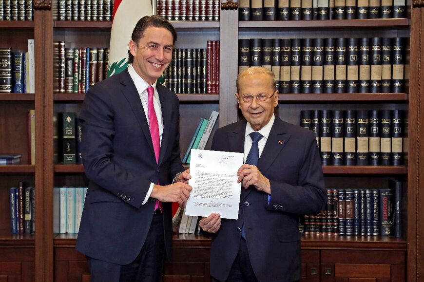 A handout picture provided by the Lebanese photo agency Dalati and Nohra shows Lebanon's President Michel Aoun (R) posing with US mediator Amos Hochstein at the presidential palace of Baabda, east of the Lebanese capital Beirut  