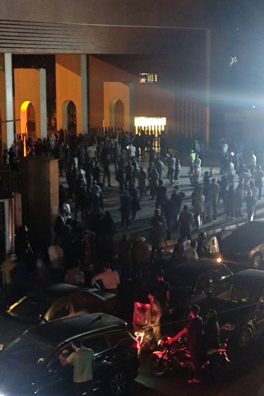 Crowds gather outside Tehran's Sharif University of Technology where clashes erupted overnight, in an image from a video clip made available on October 2, 2022 