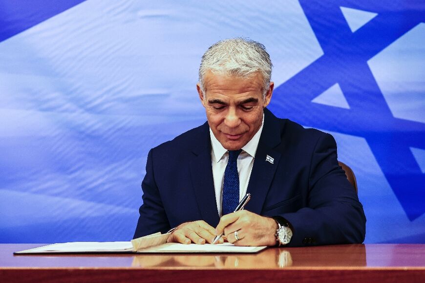 Israeli Prime Minister Yair Lapid signs the US-brokered deal setting a maritime border between Israel and Lebanon, in Jerusalem October 27, 2022