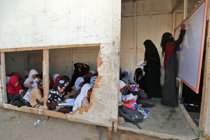 Yemeni children attend lessons at a makeshift school as the new school year starts in the war-torn western province of Hodeida, on September 12, 2022