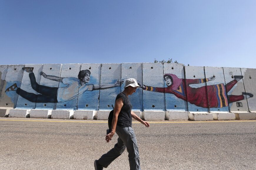 Israeli tourists seen near the northern border wall with Lebanon on October 4: the two nations have no diplomatic relations and their land border is patrolled by the United Nations