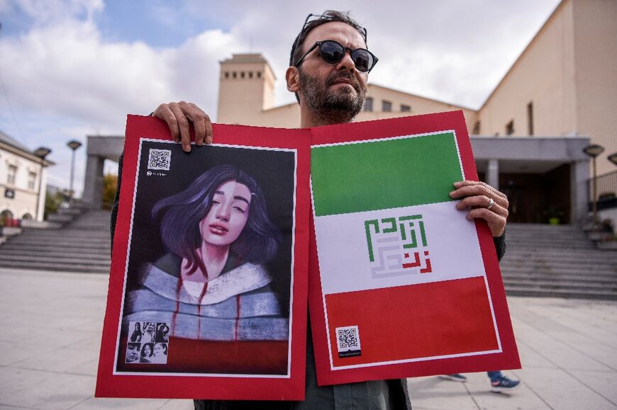 A demonstrator in Kosovo holds a portrait of Sarina Esmailzadeh, a 16-year-old killed in the Iranian crackdown