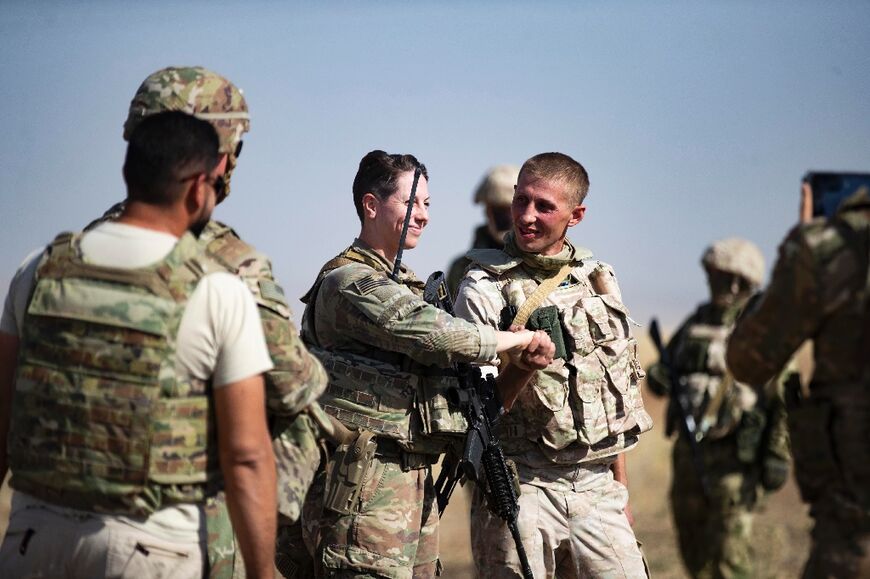 Several soldiers exchanged small patches worn on their uniform as a momento of the amicable interaction