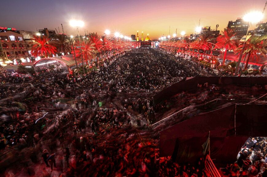 Shiite Muslim devotees gather in Iraq's holy shrine city of Karbala on September 16, 2022, the eve of Arbaeen marking 40 days after the holy day of Ashura commemorating the seventh century killing of Imam Hussein