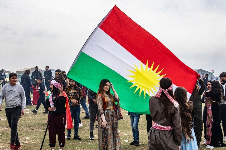 Syrian Kurds celebrate their Nowruz New Year on March 21, 2022 in Qahtaniyah in the northeastern Hasakah province close to the border with Turkey