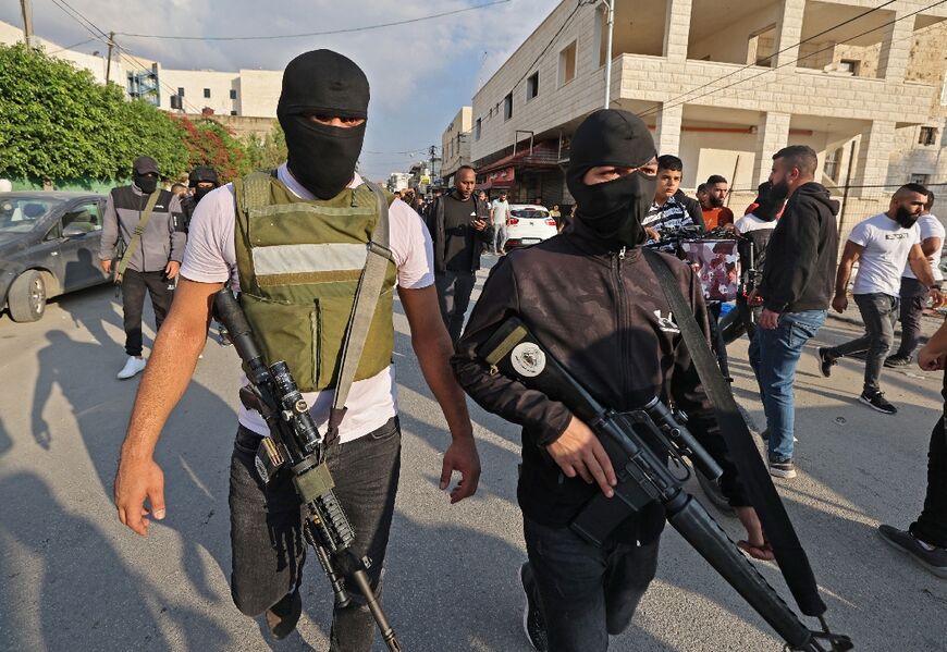 Palestinian gunmen patrol in Jenin in the occupied West Bank on Thursday after a raid by Israeli forces