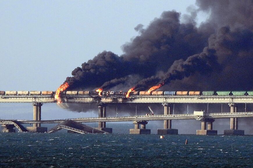 Black smoke billows from a fire on the Kerch bridge that links Crimea to Russia, after a truck exploded, near Kerch, on October 8, 2022