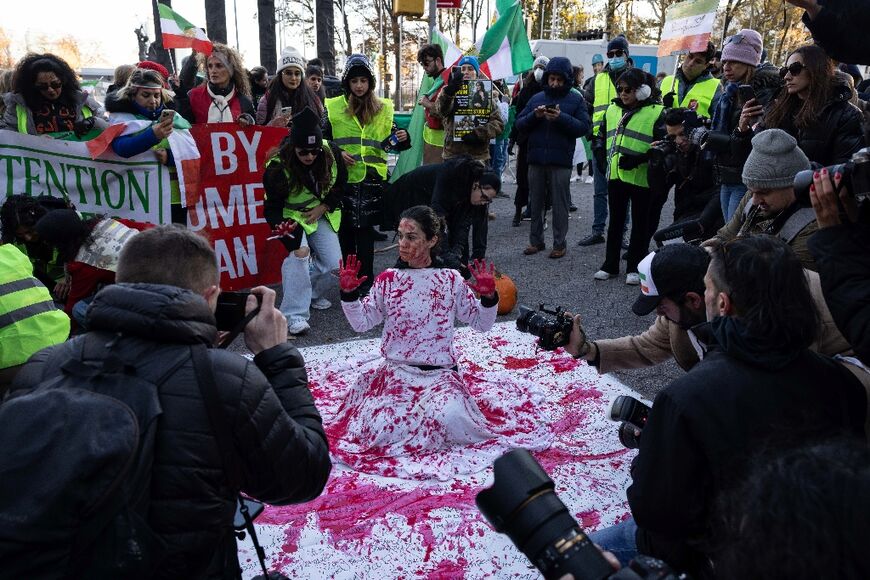 Naz Gharai from Tehran is covered in red paint as protesters call on the United Nations to take action against the treatment of women in Iran following the death of Mahsa Amini, at a protest near UN headquarters in New York City on November 19