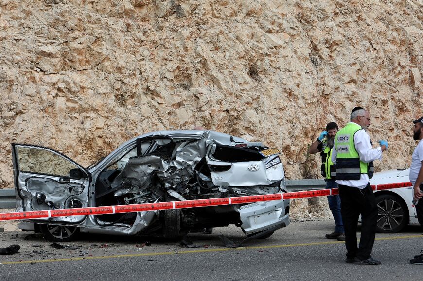 Israeli emergency services cordon off one of the scenes of the stabbing and car-ramming rampage in which a Palestinian killed three Israelis and wounded several more before being shot dead
