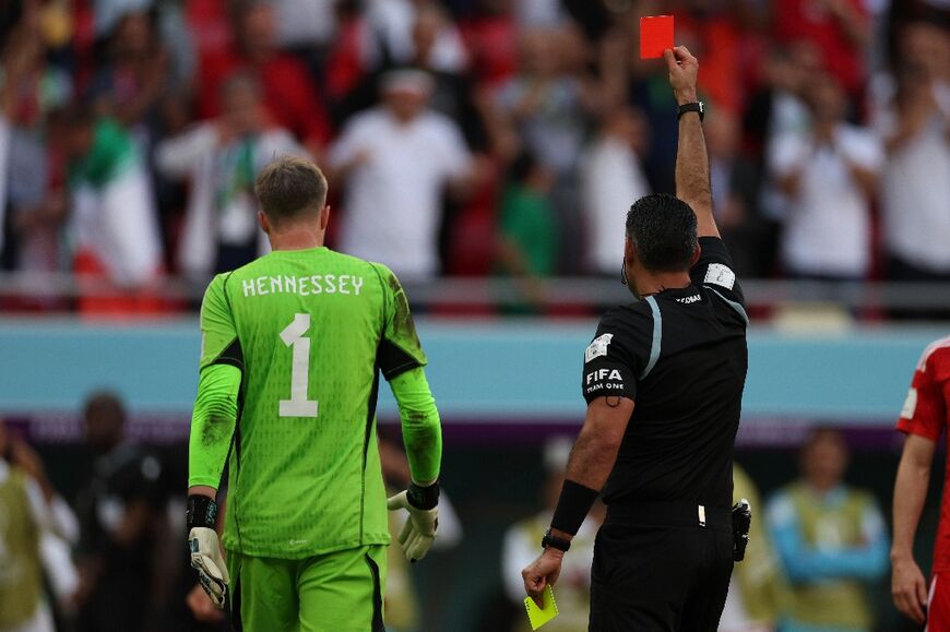 Guatemalan referee Mario Escobar shows the first red card of the World Cup to Wales goalkeeper Wayne Hennessey