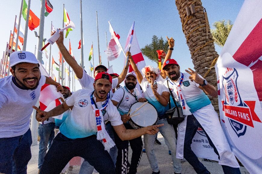Football fans supporting England cheer in Doha
