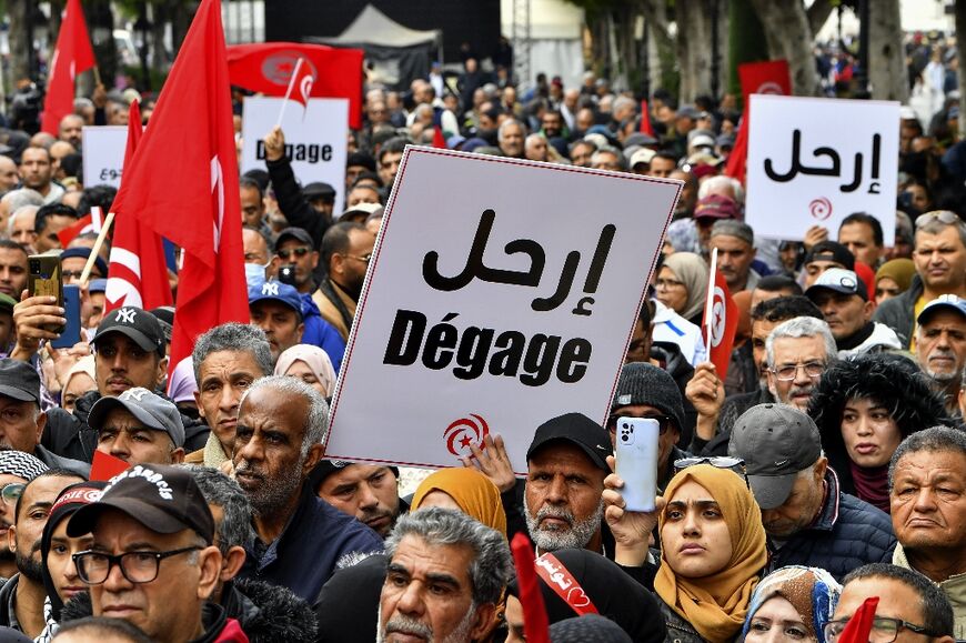 Tunisian demonstrators take part in a rally against President Kais Saied in the capital Tunis on December 10