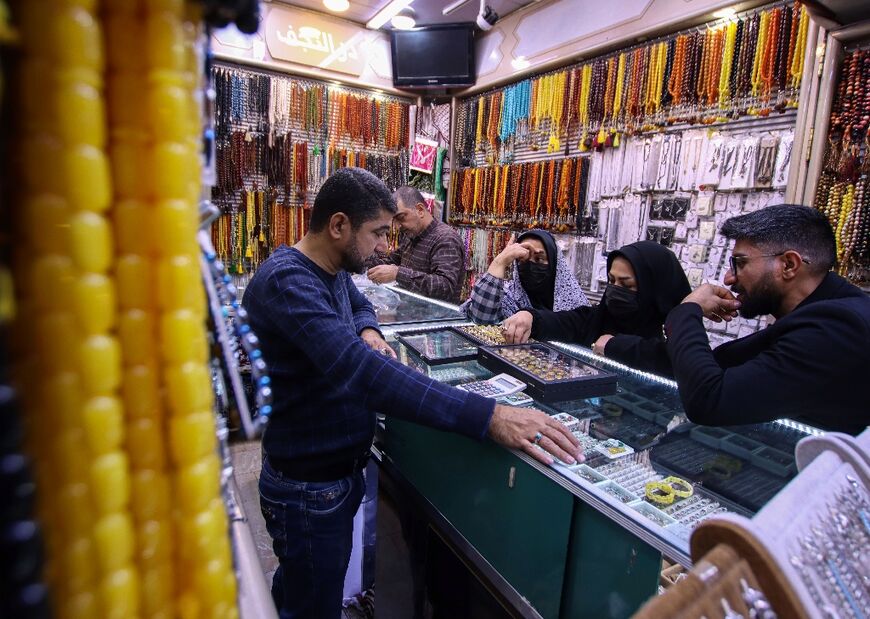 Iranian visitors shop for rings at a jewellery store in the Iraqi city of Najaf