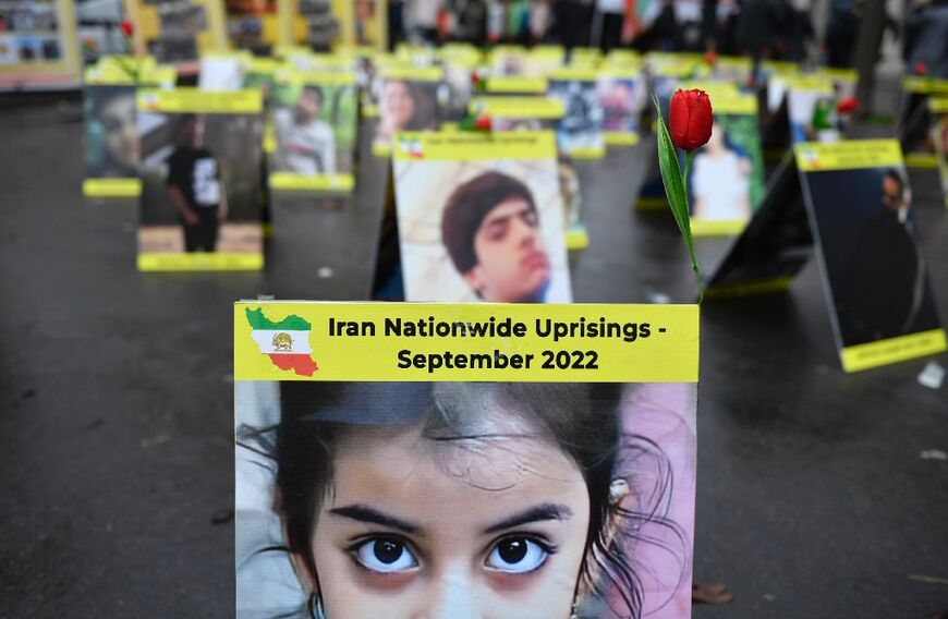 Placards with portraits of the victims of Iran's repression are seen on display near the French National Assembly