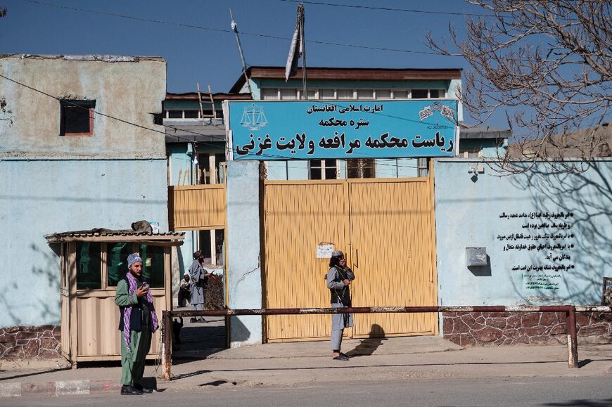 Taliban security guards the entrance gate of the Ghazni Court of Appeal in Ghazni, eastern Afghanistan