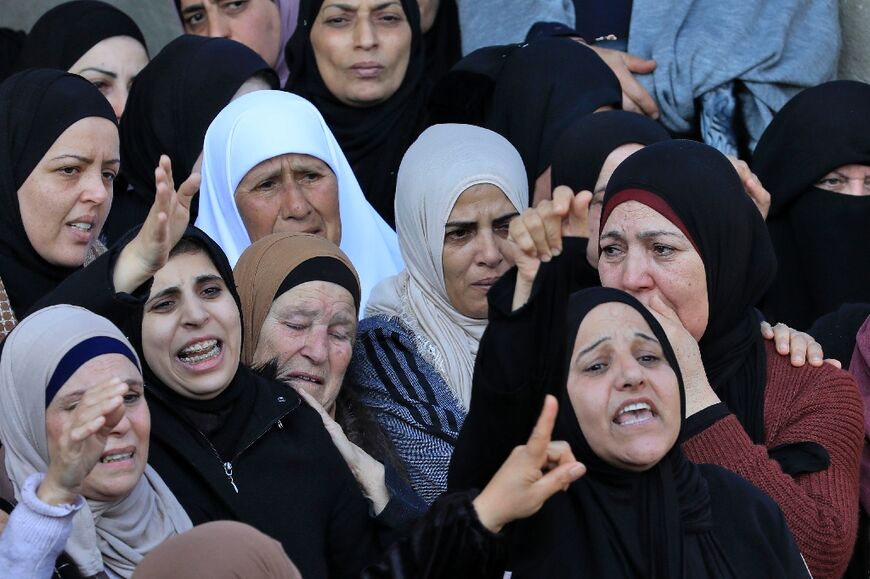Palestinian relatives mourn during the funeral of Ahmed Atef Daraghmeh, 23, killed during clashes with Israeli forces on December 22 in the occupied West Bank