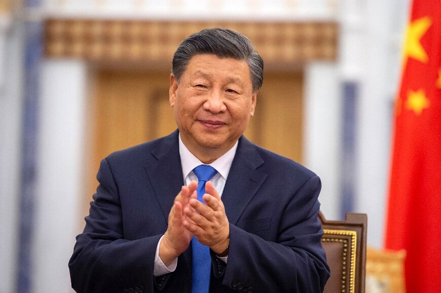 President Xi applauds after signing an agreement with Saudi King Salman bin Abdulaziz (not pictured)