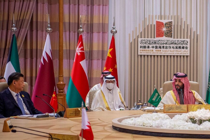 Saudi Crown Prince Mohammed bin Salman (R) addresses Chinese President Xi Jinping (L) during a GCC-China Summit on Friday