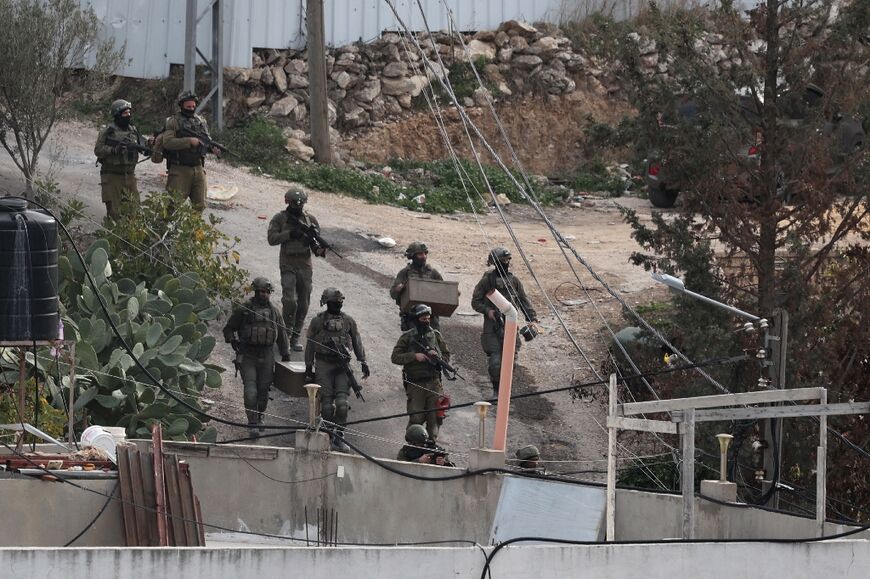 Israeli soldiers are pictured in the Palestinian village of Kafr Dan in Jenin on January 2, 2023, during an operation to demolish the homes of two Palestinians accused of killing an Israeli soldier