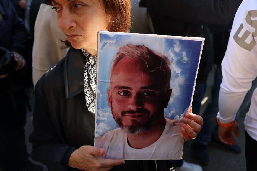 One of history's biggest non-nuclear explosions, the August 4, 2020 blast killed more than 215 people: here a relative holds a poster of one of the dead