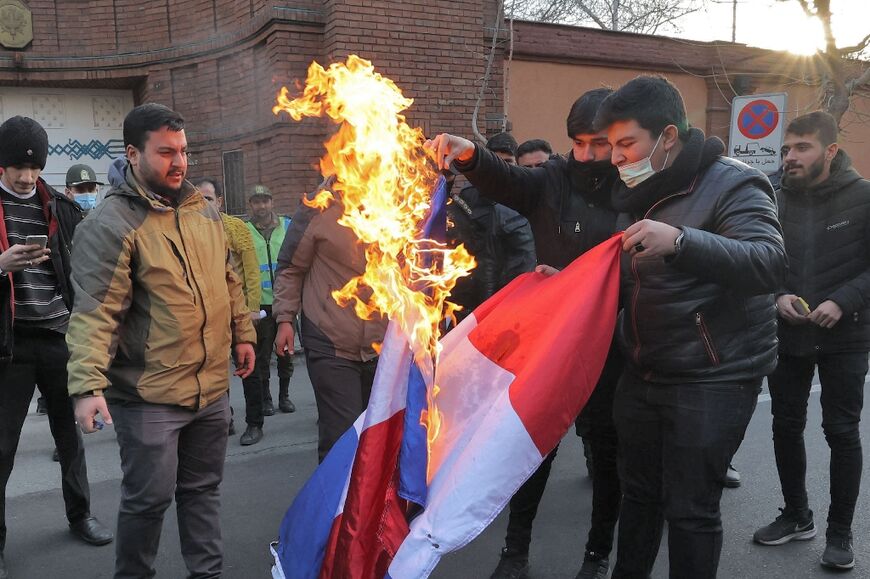 Demonstrators in Iran burn a French flag during a protest against cartoons of the Islamic republic's supreme leader Ayatollah Ali Khamenei published by French satirical weekly Charlie Hebdo