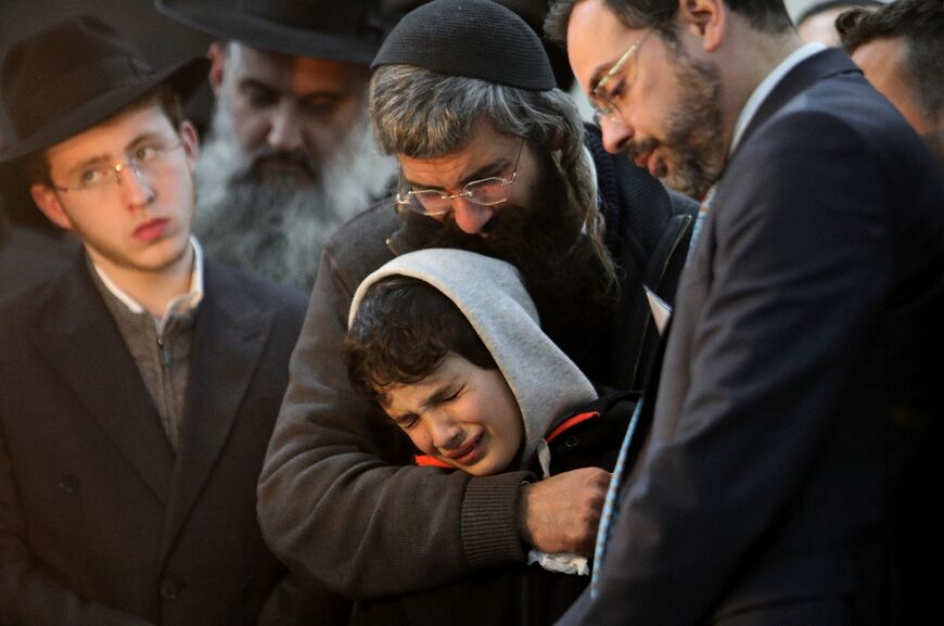 Aharon Natan, the father of 14-year-old Asher Natan, a victim of a shooting attack in east Jerusalem on January 27, 2023, mourns at the cemetery