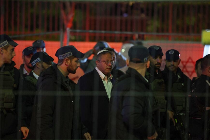 Israel's far-right National Security Minister Itamar Ben-Gvir is escorted by police on a visit to the site of the attack outside a synagogue in annexed east Jersualem