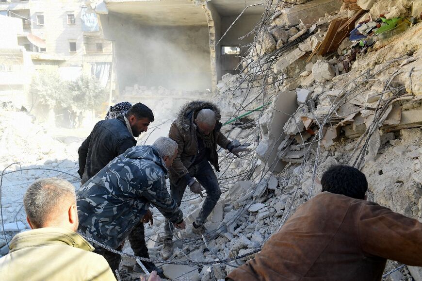 Dozens of rescue workers toiled at the site, some using their bare hands to dig into the rubble