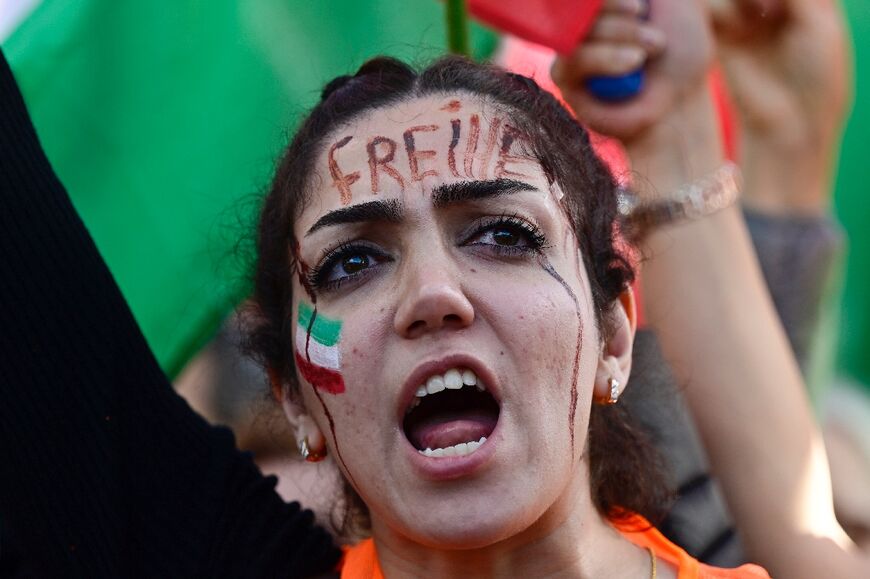Protesters like this one in Germany, with the word 'Freedom' on her forehead, have influenced elements of the Iranian regime, an analyst said