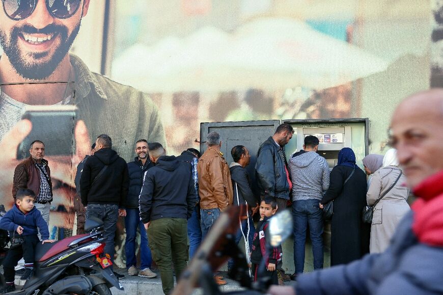 People queue outside a bank in Beirut. Lebanon once boasted the monicker 'Switzerland of the Middle East' for its role as a regional financial centre