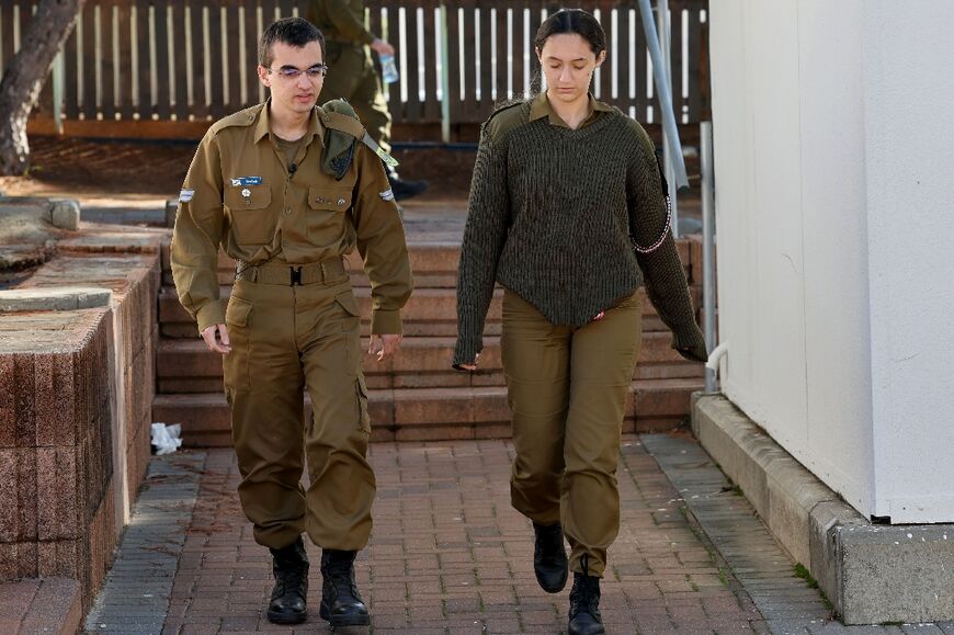 Israeli army soldier Nathan Saada, on the left, with fellow soldier Liri Shahar, 19, at a military base in Tel Aviv