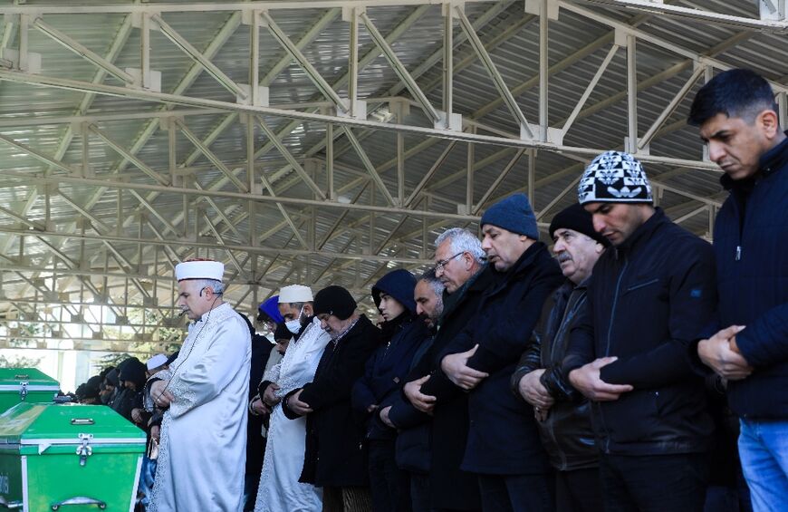 Relatives mourn victims as imams bless the deceased