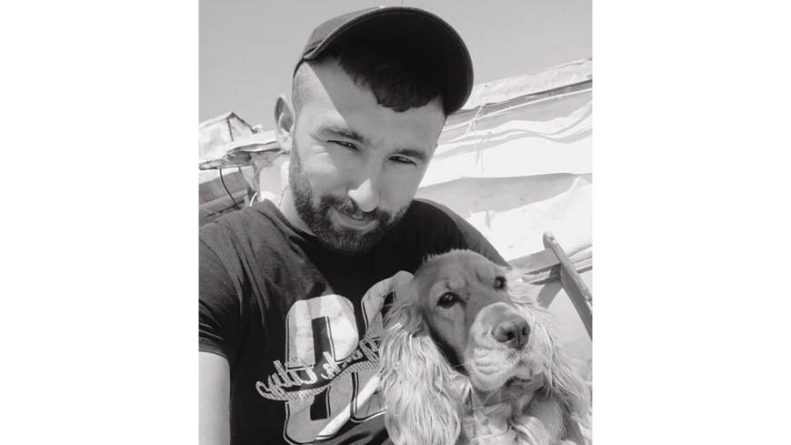 Ahmet Guresci, 26, with his pet cocker spaniel Odi shortly before his death in police custody on Feb. 11. (Image courtesy of the Guresci family)