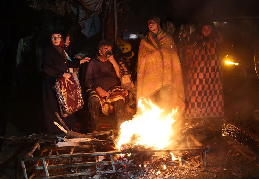 Many across Turkey's quake-hit regions spent the night huddling around makeshift fires for warmnth