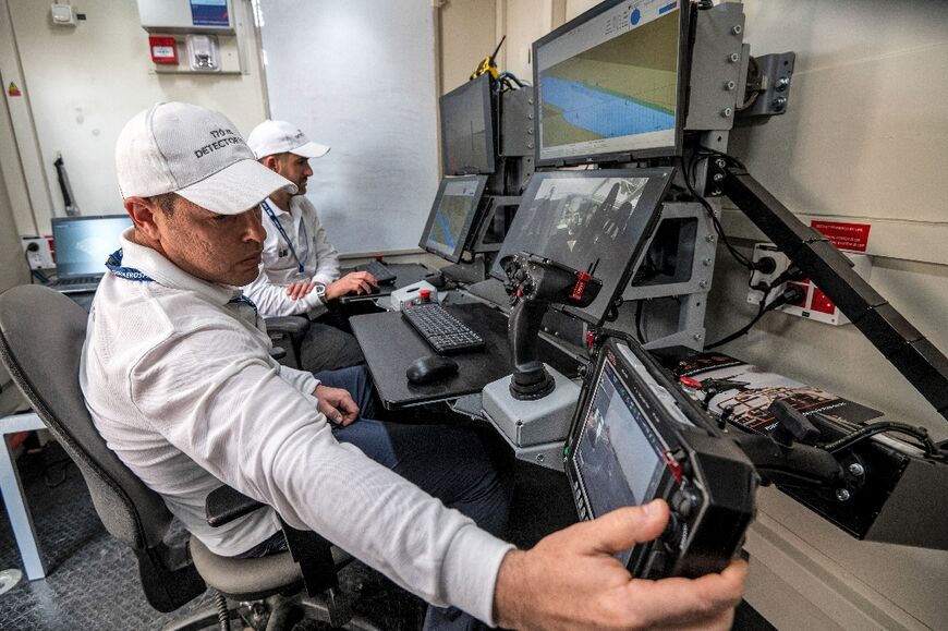 Controllers man a terminal at the command station of the Israel Aerospace Industries in an unmanned maritime demonstration during the Naval Defence and Maritime Security Exhibition (NAVDEX) at the Abu Dhabi International Exhibition Centre 