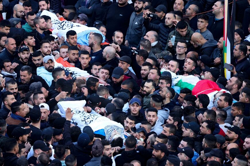 Mourners carry bodies of Palestinians killed in a raid by Israeli forces on the occupied West Bank city of Nablus