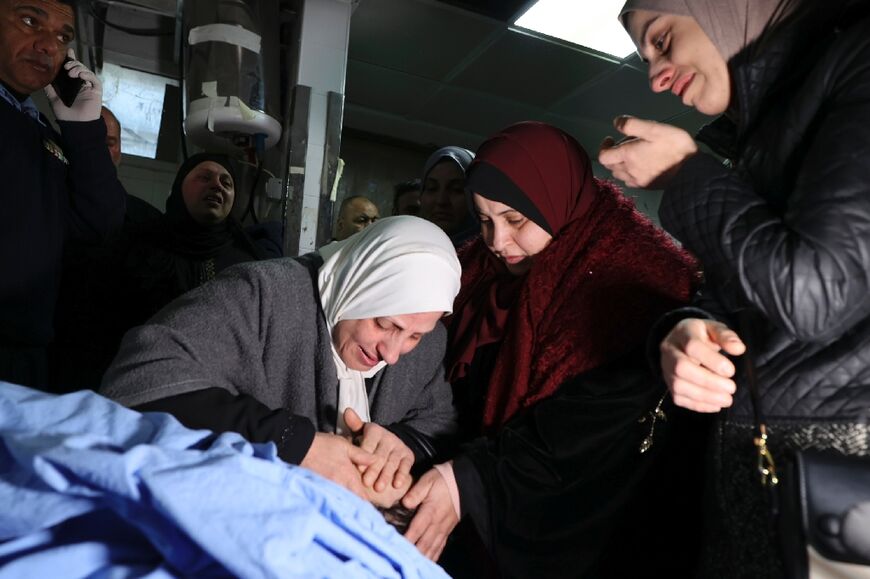 Palestinian relatives mourn Amir Ihab Bustami, who was killed in a predawn Israeli army raid, at a hospital morgue in Nablus in the occupied West Bank on February 13, 2022