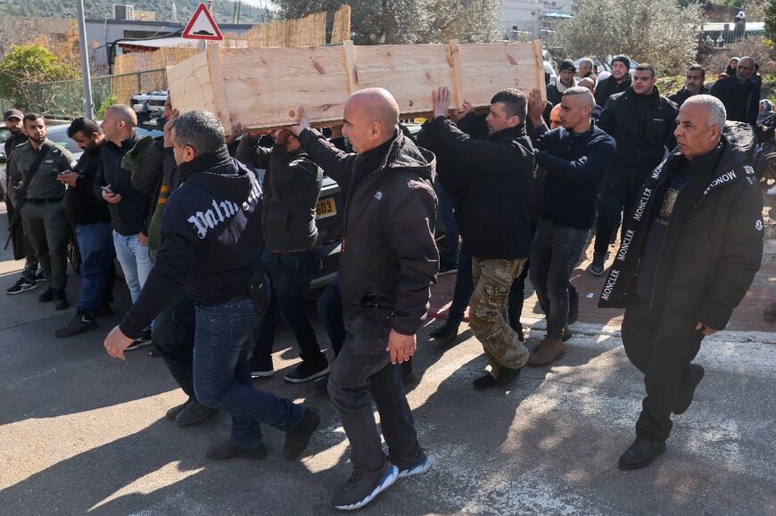 Mourners carry the coffin of Israeli policeman Asil Sawaed, who was killed in a stabbing attack carried out by a Palestinian boy in annexed east Jerusalem, during his funeral in the Bedouin town of Husayniyya in northern Israel